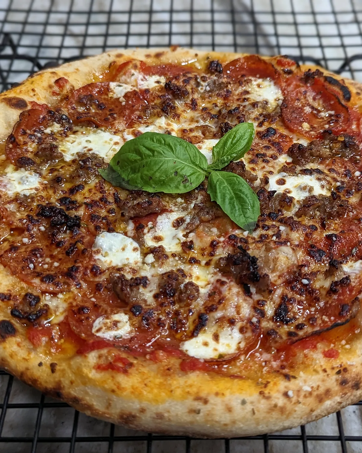 Sausage and basil pizza fresh from the oven